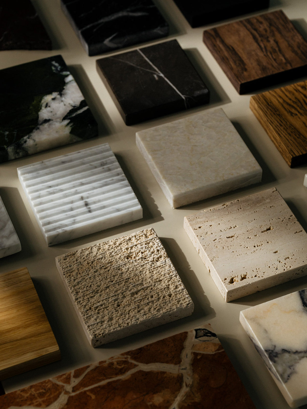     A selection of natural stone, marble and wood samples arranged together to explore unexpected material combinations.